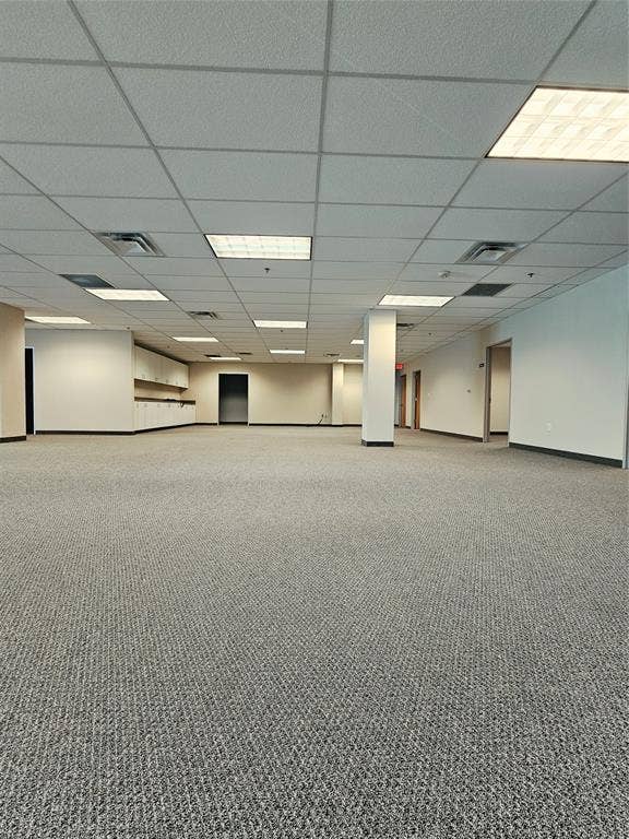 1675 Republic Parkway, #201A, Mesquite, TX 75150 Expansive open-plan area featuring textured carpet flooring, suspended acoustic tile ceiling, and recessed fluorescent lighting