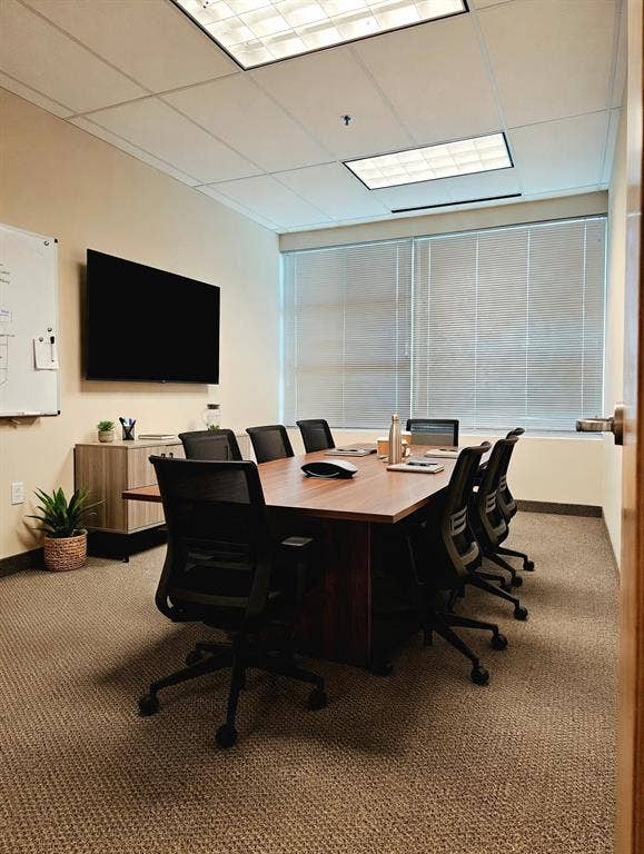 1675 Republic Parkway, #201A, Mesquite, TX 75150 Recessed lighting, wood-finish conference table, textured carpeting, large wall-mounted display, and horizontal window blinds