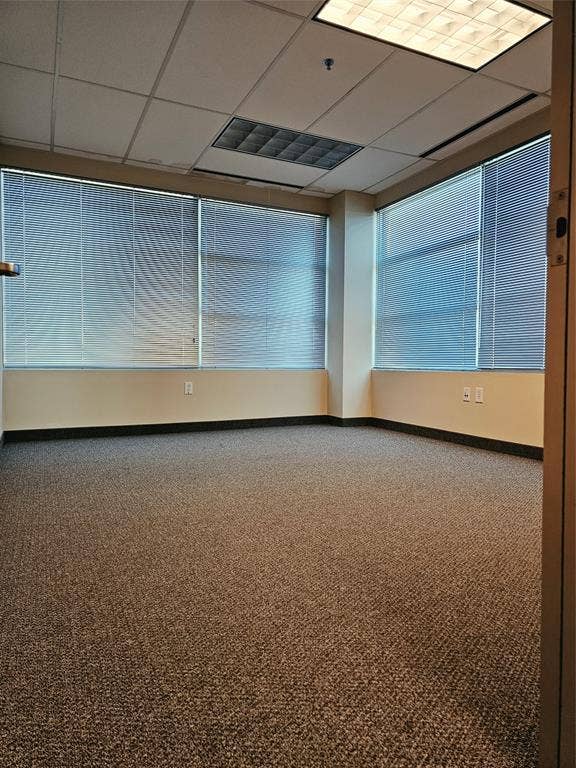 1675 Republic Parkway, #201A, Mesquite, TX 75150 Wall-to-wall carpeting with a textured finish, multiple windows with blinds, drop ceiling with recessed lighting, and a neutral wall color