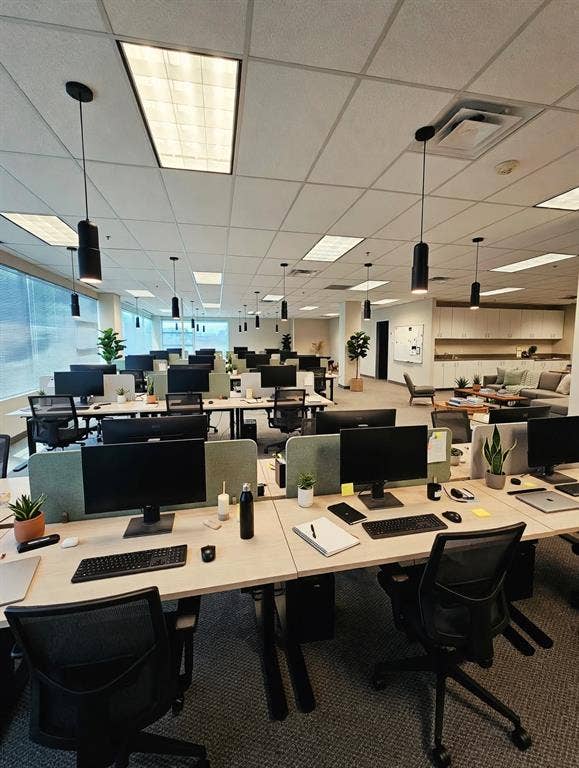 1675 Republic Parkway, #201A, Mesquite, TX 75150 Open-plan workspace featuring multiple workstations with desk dividers, suspended pendant lighting, and abundant natural light from extensive window lines
