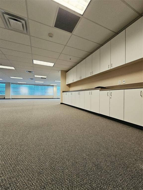 1675 Republic Parkway, #201A, Mesquite, TX 75150 Extensive built-in cabinetry, textured carpet flooring, suspended ceiling with recessed lighting, integrated air conditioning vents, and prominent windows with natural light
