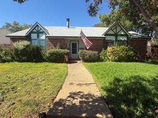 Brick exterior featuring a gabled roofline and a front walkway
