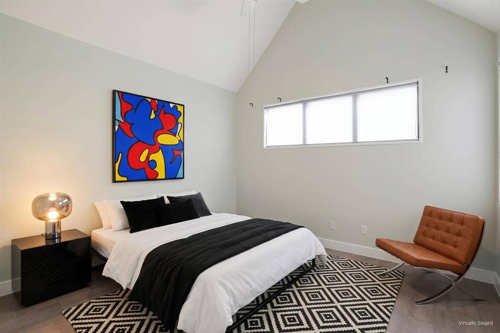 9123 Valley Chapel Lane, Dallas, TX 75220 Upstairs bedroom with vaulted ceiling and a clerestory window for privacy and natural light. Virtually staged.