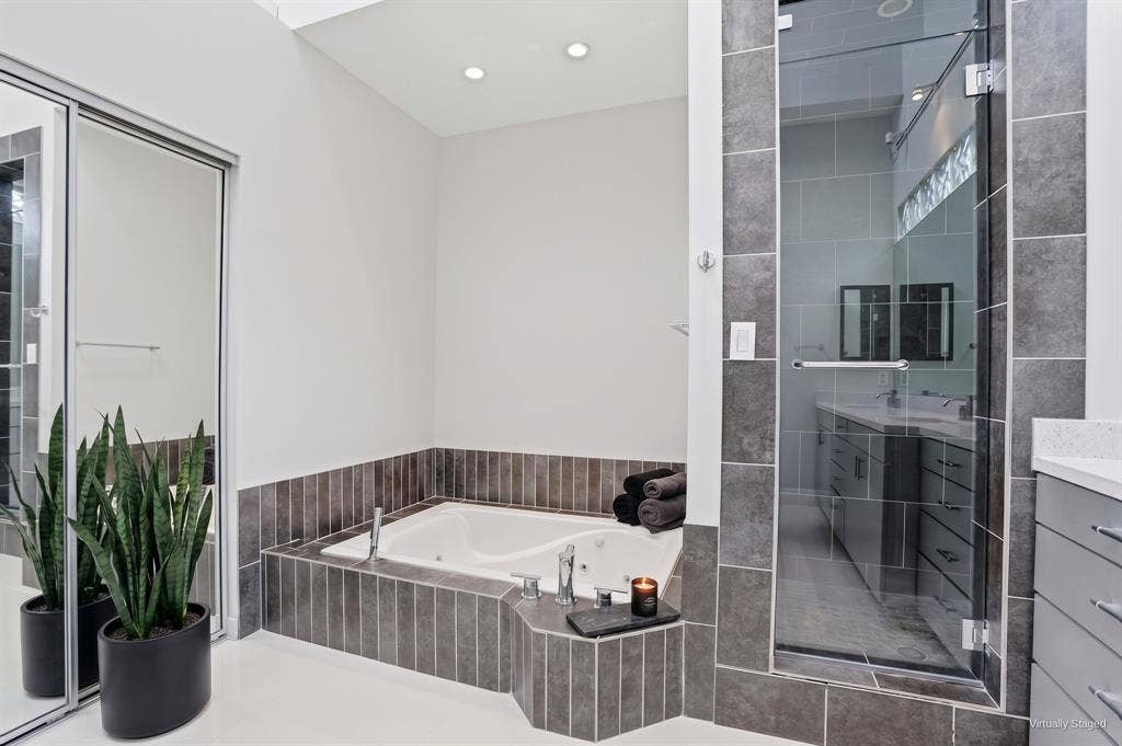 9123 Valley Chapel Lane, Dallas, TX 75220 Jetted garden tub and separate glass-enclosed walk-in shower in the primary bath. Virtually staged.