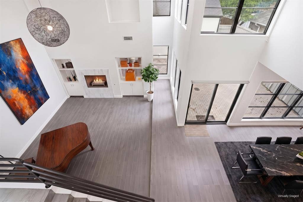 9123 Valley Chapel Lane, Dallas, TX 75220 Overhead view of the two-story great room and open floor plan, with floor-to-ceiling glass doors to the courtyard. Virtually staged.