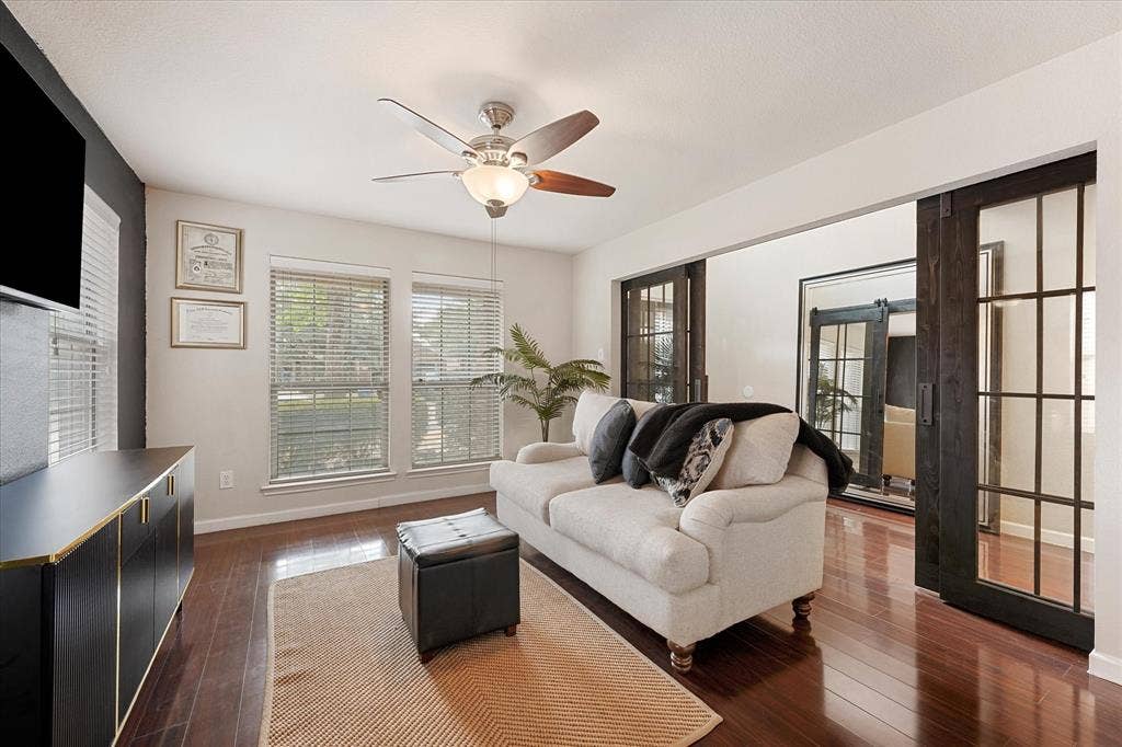 2053 Lake Trail Drive, Heartland, TX 75126 Wood-finish flooring throughout, ceiling fan with integrated lighting, and two windows with blinds