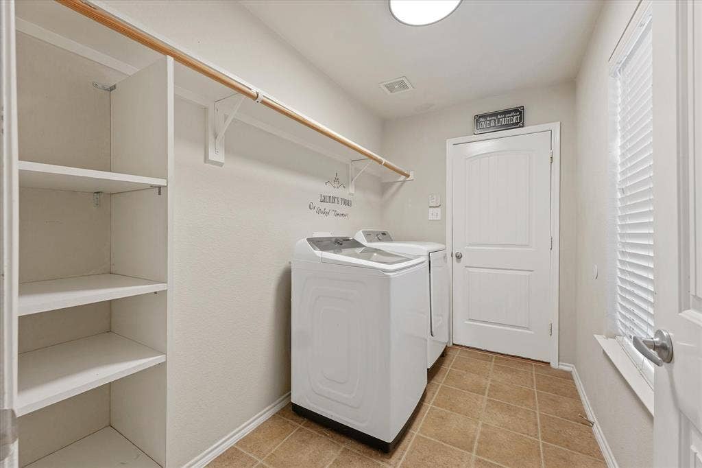 2053 Lake Trail Drive, Heartland, TX 75126 Laundry area featuring built-in shelving, a clothes rod, and tile flooring
