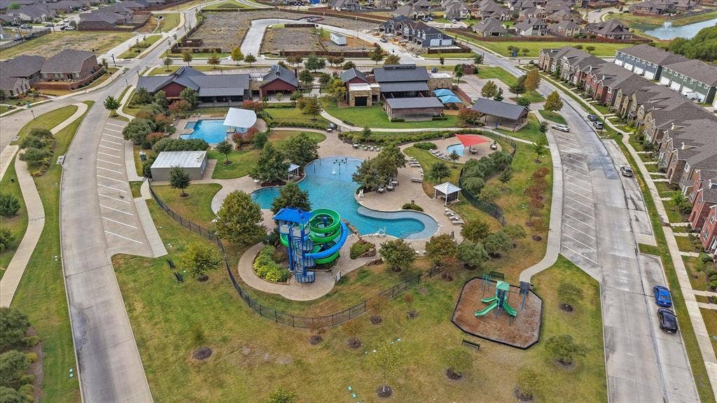 2053 Lake Trail Drive, Heartland, TX 75126 Community amenities featuring multiple swimming pools, water slides, a splash pad, and a playground