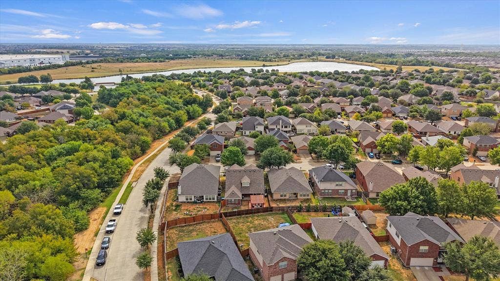 2053 Lake Trail Drive, Heartland, TX 75126 Residential neighborhood with a variety of single-family homes, mature trees, and a distant body of water