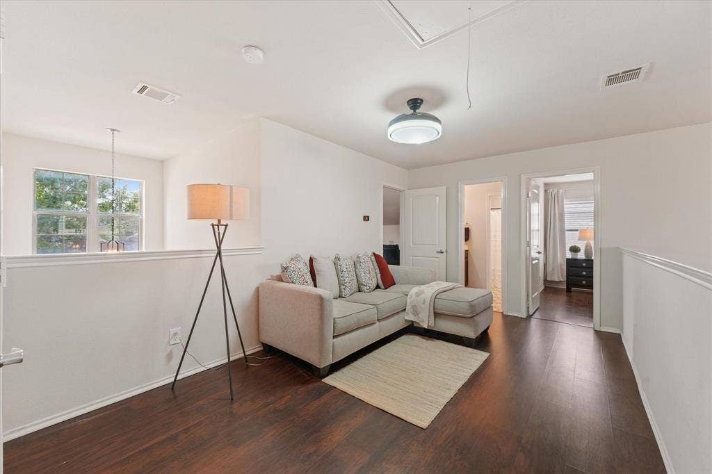 2053 Lake Trail Drive, Heartland, TX 75126 Dark wood-finish flooring, white painted walls, and a modern ceiling fixture