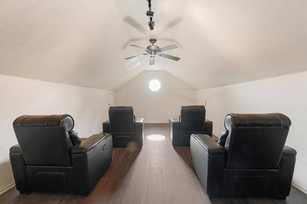 2053 Lake Trail Drive, Heartland, TX 75126 Vaulted ceiling with a ceiling fan, track lighting, wood-finish flooring, and an octagonal window