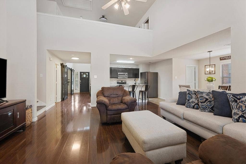 2053 Lake Trail Drive, Heartland, TX 75126 Spacious living area featuring high ceilings, wood-finish flooring, and an open-concept layout