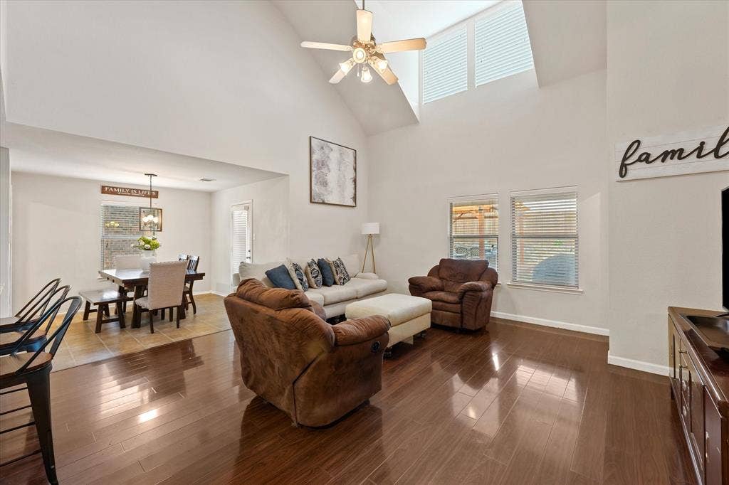 2053 Lake Trail Drive, Heartland, TX 75126 Vaulted ceiling with a ceiling fan, wood-finish flooring, multiple windows, and a recessed dining area with tile flooring