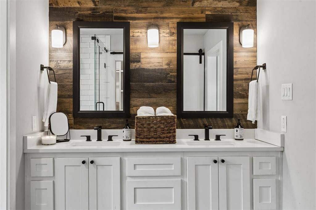 Dual vanity with white cabinetry, white countertops, and matte black fixtures