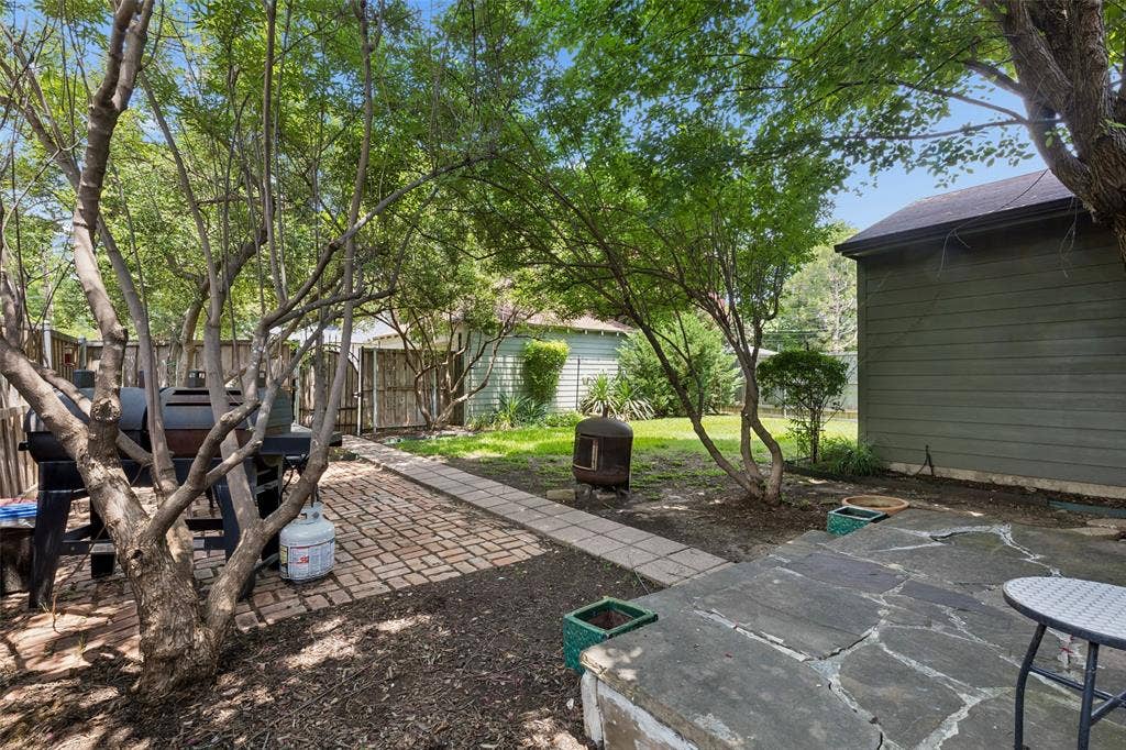 Backyard featuring a paver patio, flagstone patio, and mature trees