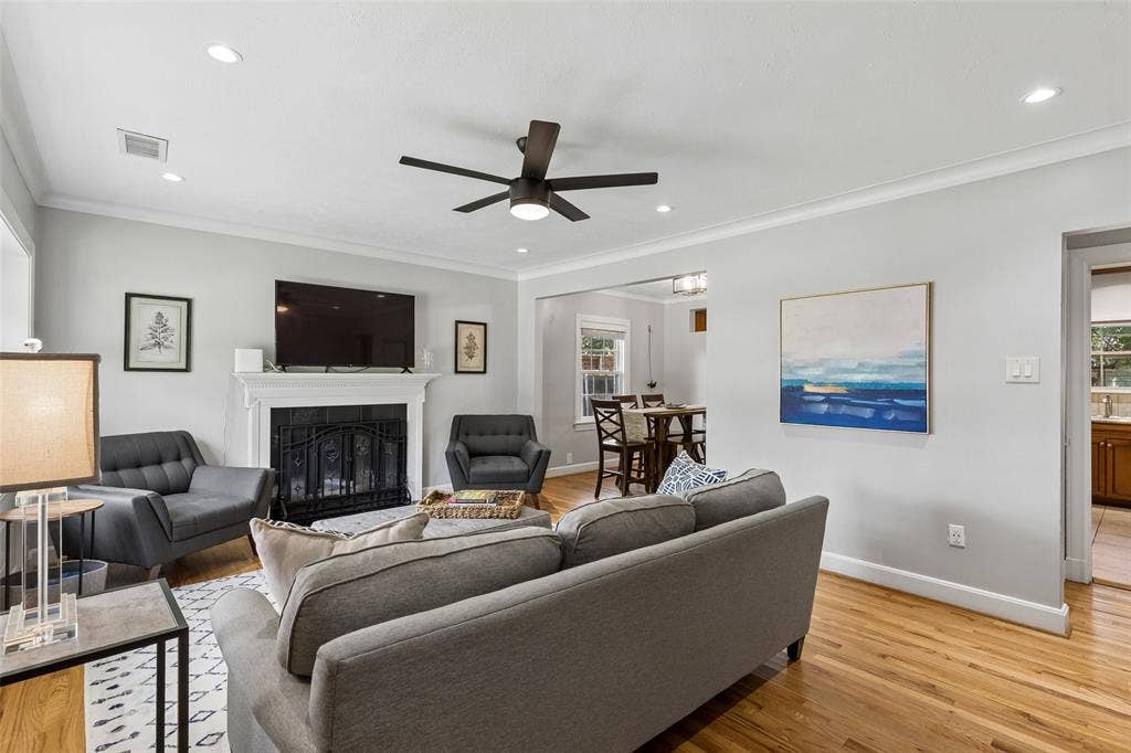 Hardwood flooring, recessed lighting, and a ceiling fan