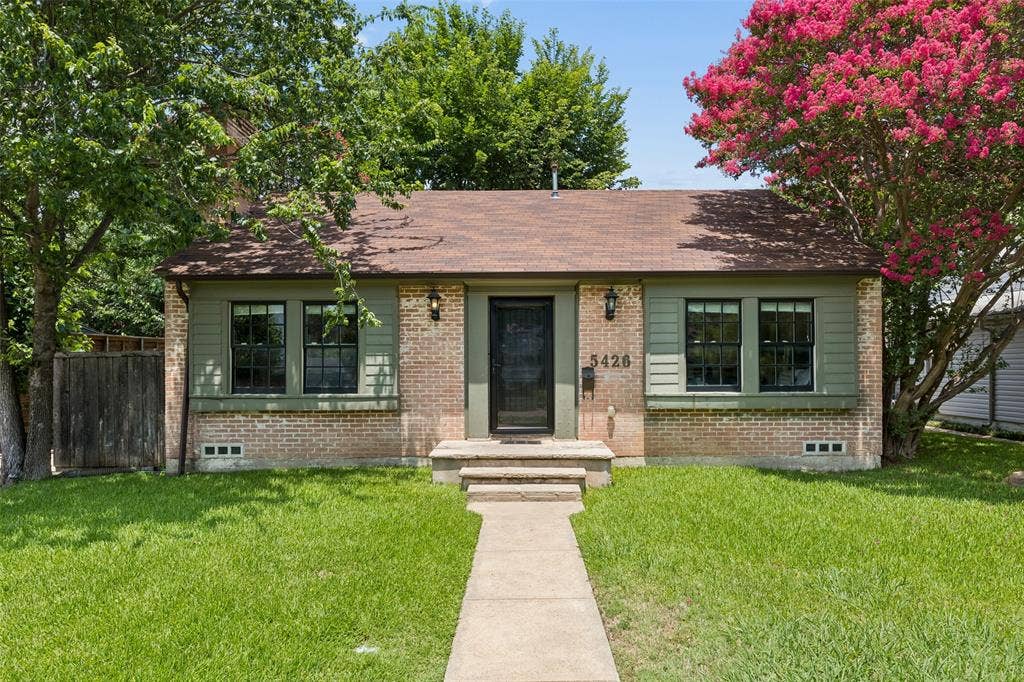 Brick and siding exterior with a brown shingle roof