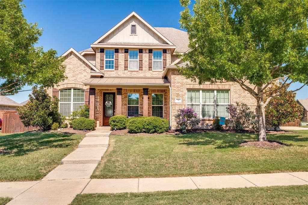 741 Darian Drive, Prosper, TX 75078 Brick exterior with contrasting wood-finish shutters, covered front porch, and a dormer window