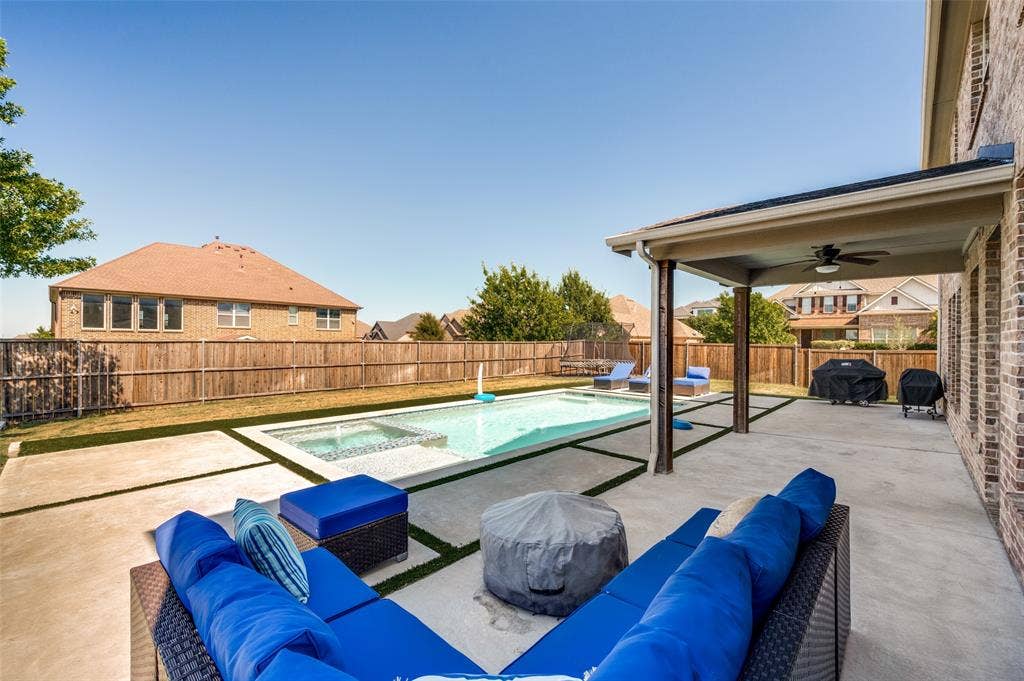 741 Darian Drive, Prosper, TX 75078 Backyard featuring a rectangular pool with an integrated spa, expansive concrete patio, and covered patio with a ceiling fan