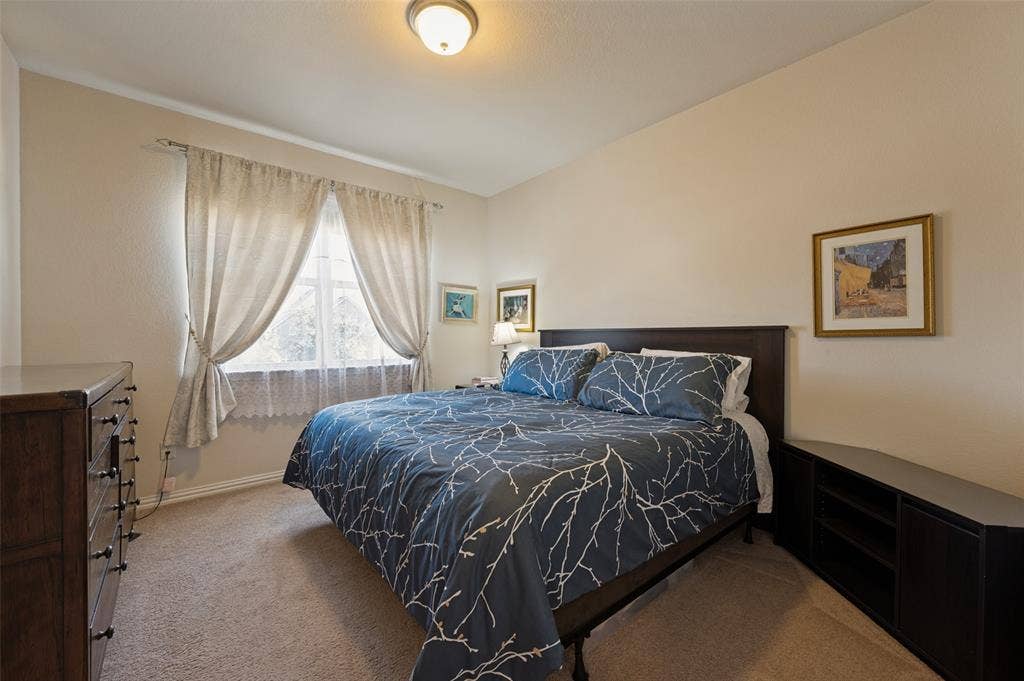 741 Darian Drive, Prosper, TX 75078 Carpeted flooring with light-toned walls, a double window with drapes, and a ceiling-mounted light fixture