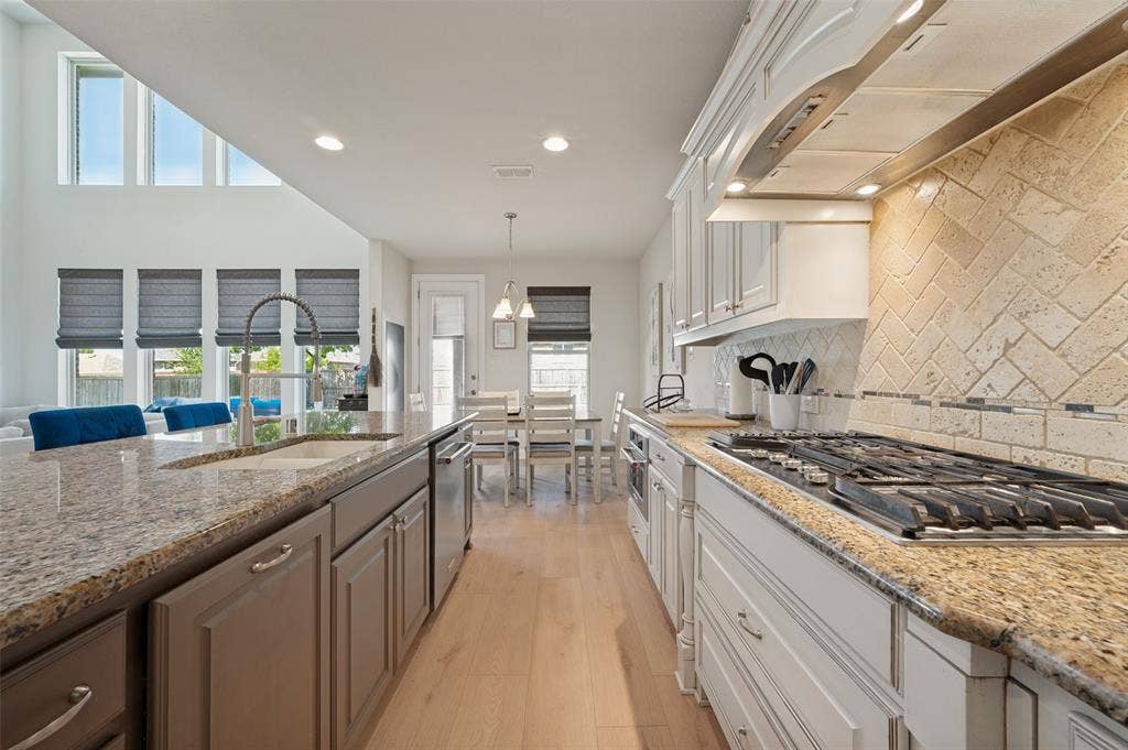 741 Darian Drive, Prosper, TX 75078 Kitchen featuring granite countertops, wood-finish flooring, stainless steel appliances, a tile backsplash, and recessed lighting