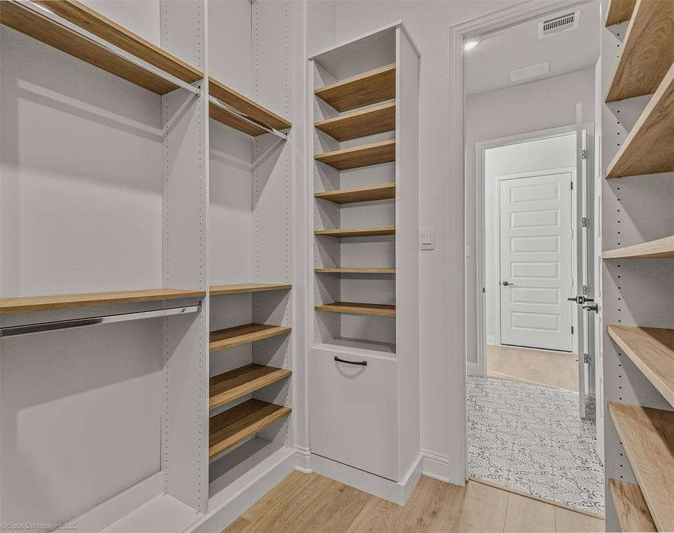 2601 Lafayette Drive, Rowlett, TX 75088 Integrated custom shelving, wood-finish flooring, built-in closet rods, and a paneled interior door