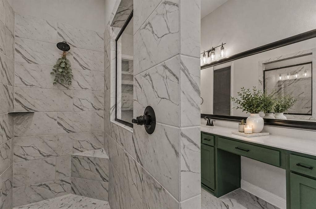 2601 Lafayette Drive, Rowlett, TX 75088 Curbless shower with marble-look tile, built-in shower bench, and matte black fixtures