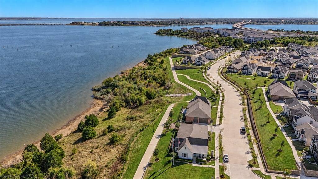 2601 Lafayette Drive, Rowlett, TX 75088 Aerial perspective of a developed residential community featuring waterfront properties, a winding street, and manicured green spaces