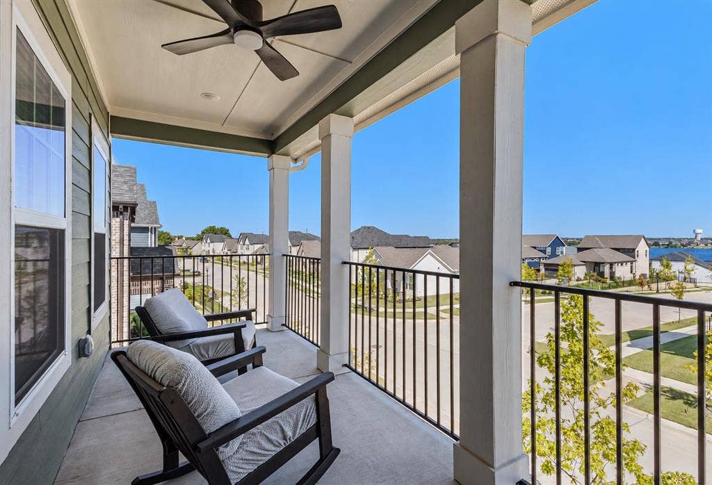 2601 Lafayette Drive, Rowlett, TX 75088 Covered balcony with a ceiling fan, concrete flooring, and black metal railings