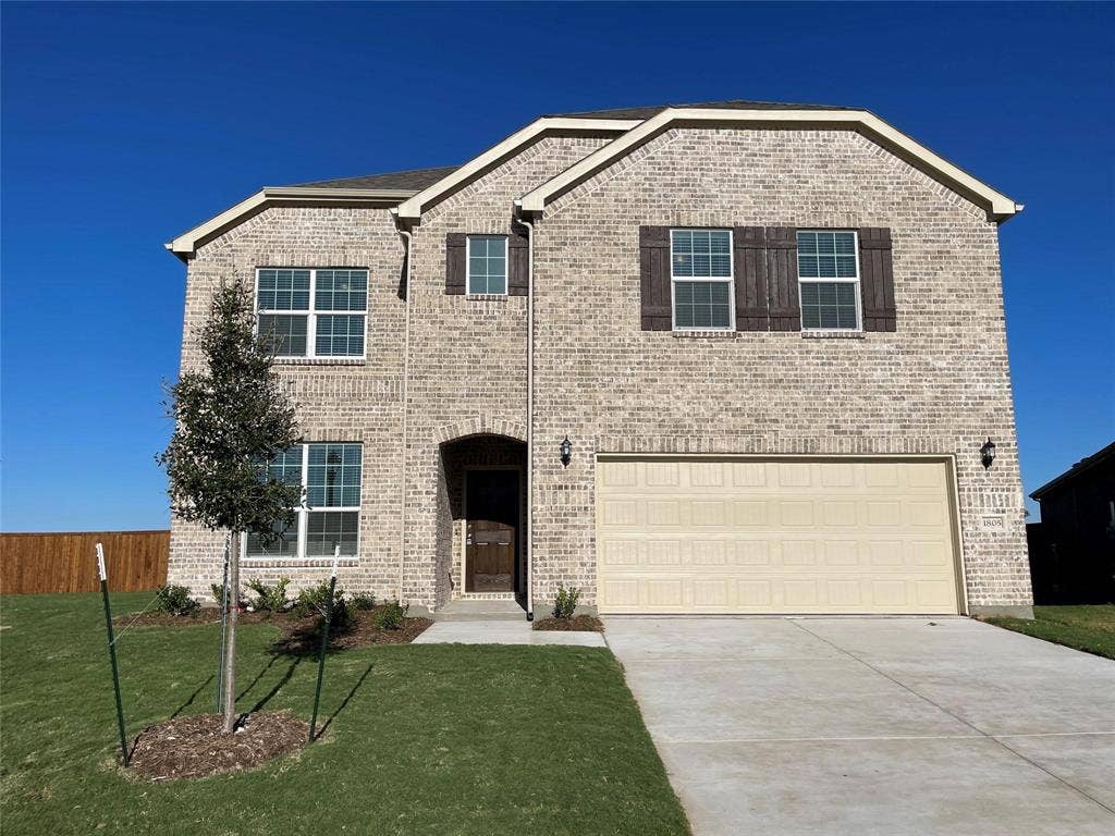 1805 Nelson Street, Anna, TX 75409 Two-story residence featuring a brick exterior, an arched entryway, a two-car garage, and a concrete driveway