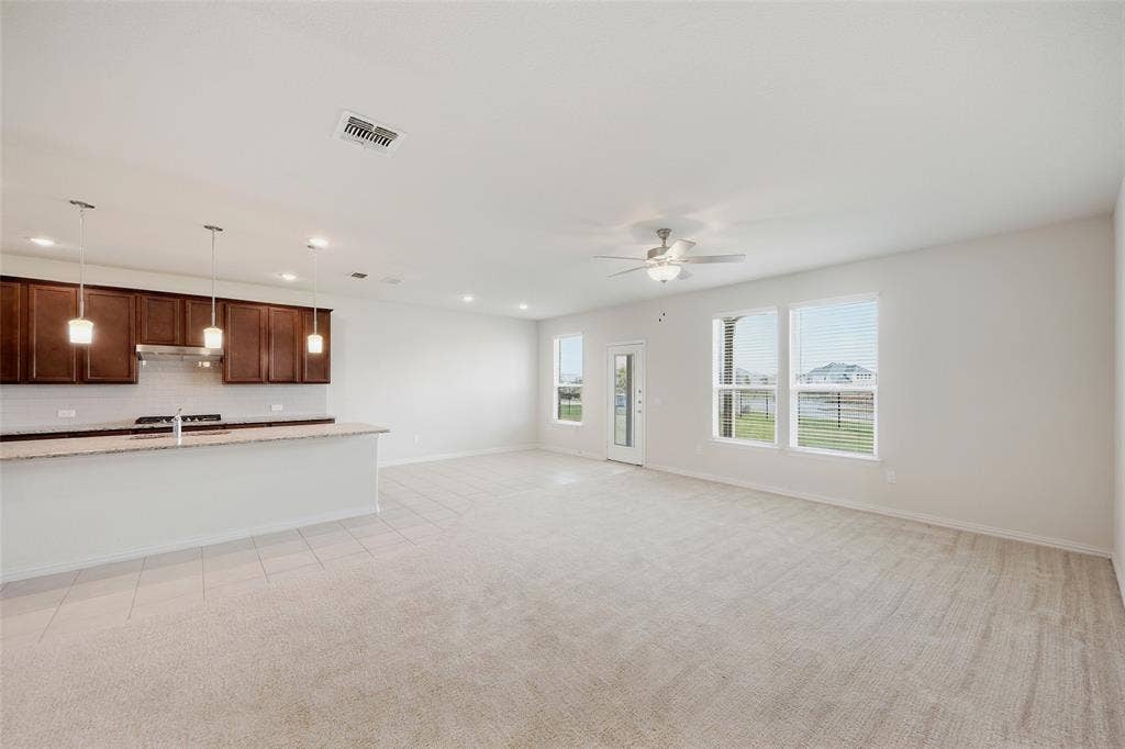 1805 Nelson Street, Anna, TX 75409 Open-concept living area with light-toned carpet and recessed lighting