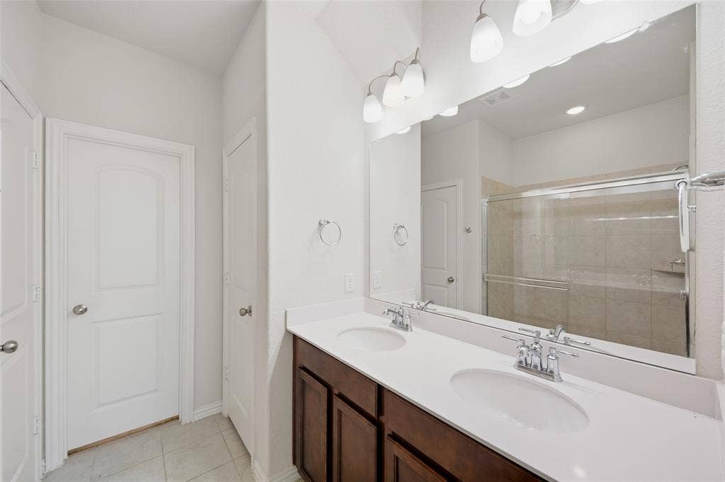 1805 Nelson Street, Anna, TX 75409 Dual vanity with white countertops, undermount sinks, and chrome faucets