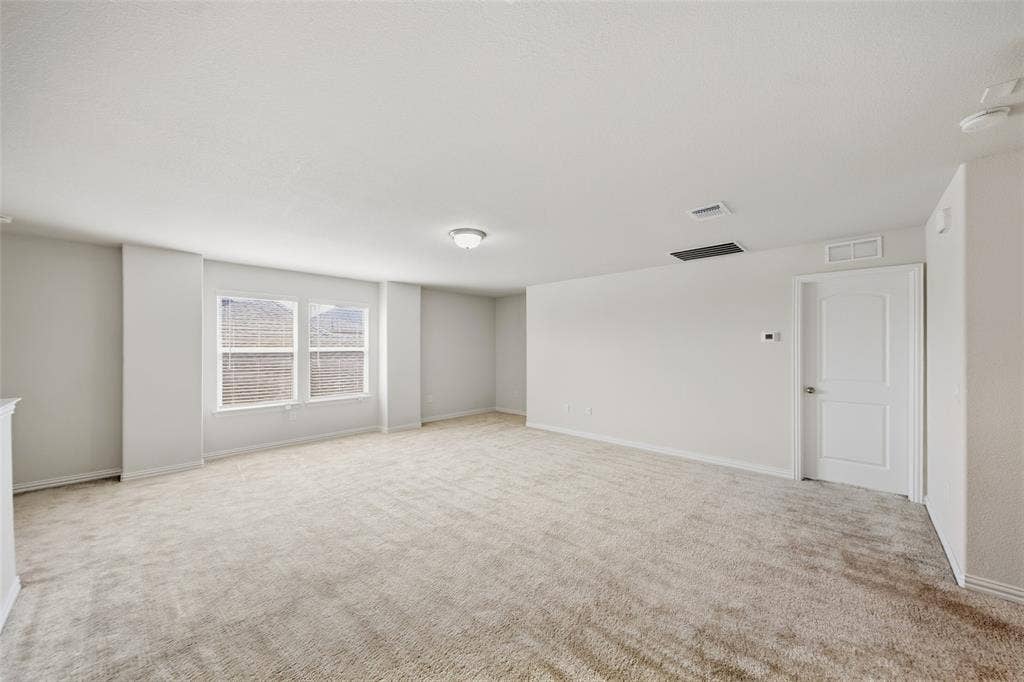1805 Nelson Street, Anna, TX 75409 Spacious room with light-toned carpeting, white walls, and a pair of windows