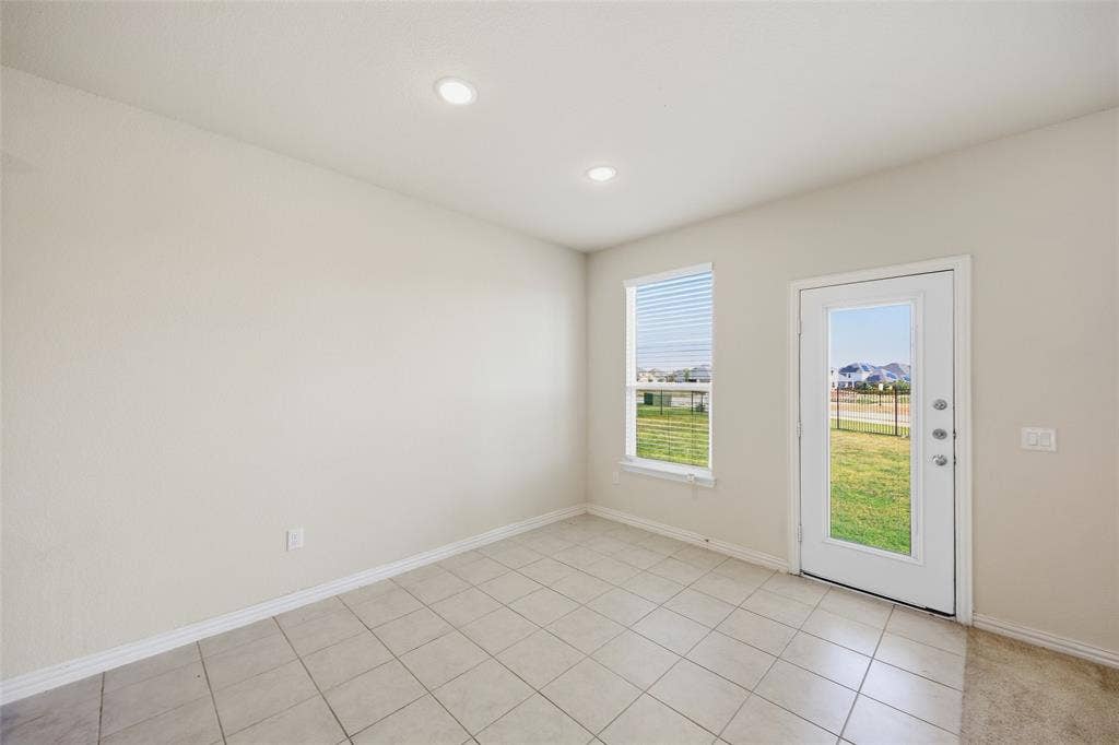 1805 Nelson Street, Anna, TX 75409 Recessed ceiling lighting, tiled flooring, single window with blinds, full-lite exterior door, light-toned wall finish