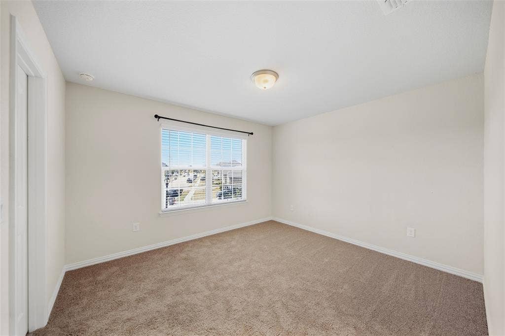 1805 Nelson Street, Anna, TX 75409 Neutral-toned walls, carpeted flooring, and a flush mount lighting fixture