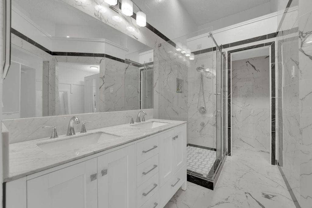 Dual vanity with white cabinetry and chrome hardware