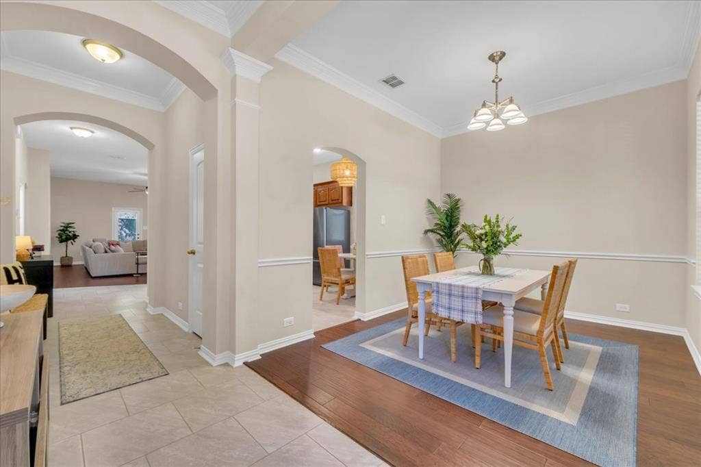 5612 Hampshire Drive, McKinney, TX 75070 Archway entries, crown molding, chair rail detailing, wood-finish flooring, and recessed lighting