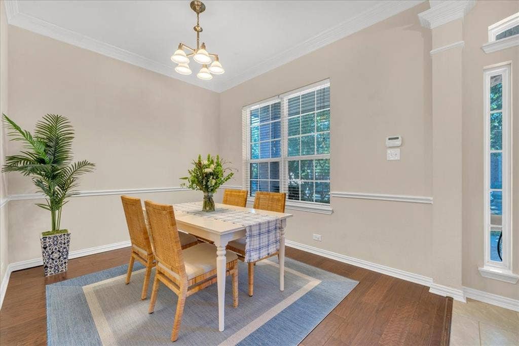5612 Hampshire Drive, McKinney, TX 75070 Wood-finish flooring, crown molding, chair rail molding, and a multi-pane window with blinds