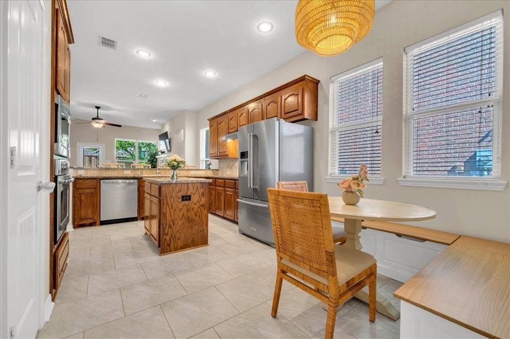 5612 Hampshire Drive, McKinney, TX 75070 Kitchen featuring recessed lighting, a central island, wood cabinetry, stainless steel appliances, and tile flooring