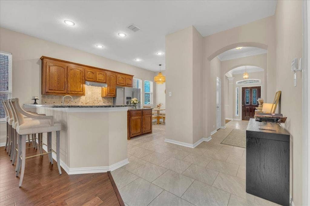 5612 Hampshire Drive, McKinney, TX 75070 Kitchen featuring wood cabinetry, stainless steel appliances, and recessed lighting