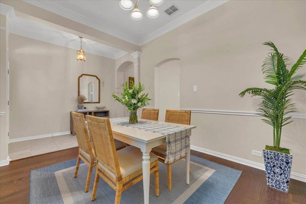 5612 Hampshire Drive, McKinney, TX 75070 Wood-finish flooring, crown molding, and chair rail detailing