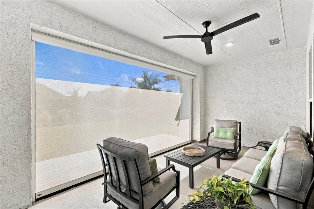 The extended covered patio features a remote-controlled retractable screen, creating a comfortable, versatile space for outdoor relaxation and entertaining.