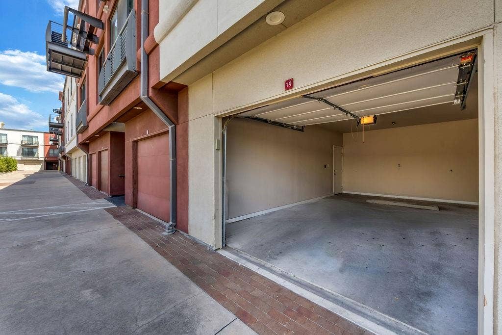 4605 Cedar Springs Road, #327, Dallas, TX 75219 Spacious garage with concrete flooring, automatic garage door opener, and interior access door