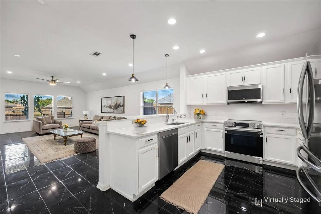 221 Cliffbrook Drive, Wylie, TX 75098 Kitchen featuring stainless steel appliances, white cabinetry, and white countertops