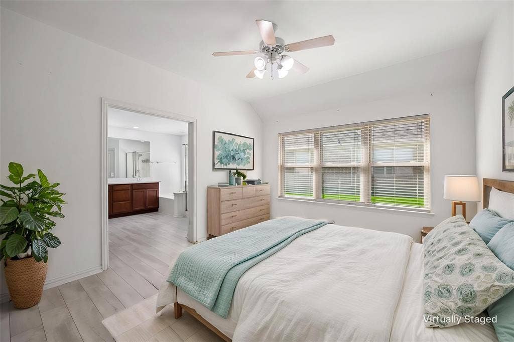 221 Cliffbrook Drive, Wylie, TX 75098 Vaulted ceiling with a ceiling fan, three-panel window with blinds, and light-tone wood-finish flooring