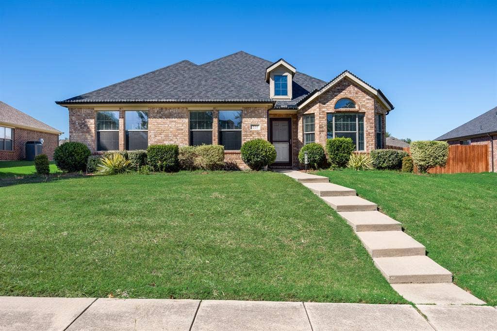 221 Cliffbrook Drive, Wylie, TX 75098 Brick exterior with an asphalt shingle roof