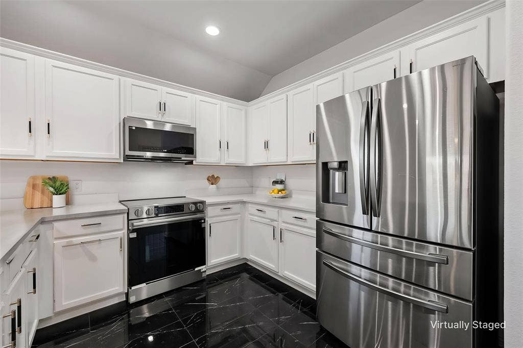 221 Cliffbrook Drive, Wylie, TX 75098 White shaker cabinetry, stainless steel appliances, black marble-look flooring, light-toned countertops, and a white subway tile backsplash