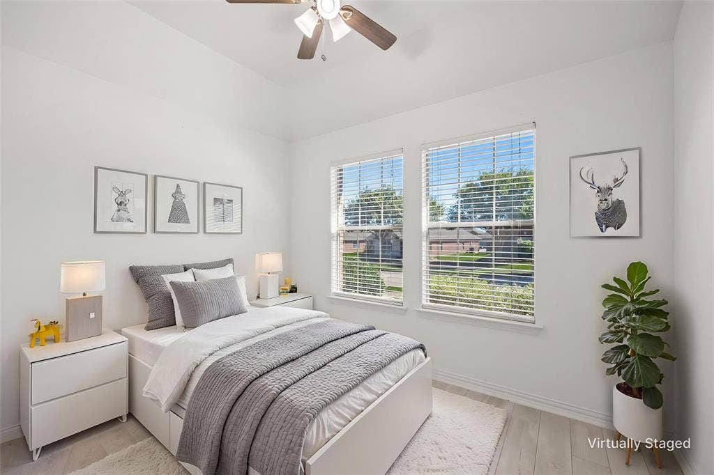 221 Cliffbrook Drive, Wylie, TX 75098 Vaulted ceiling with a ceiling fan, two windows, and light wood-finish flooring