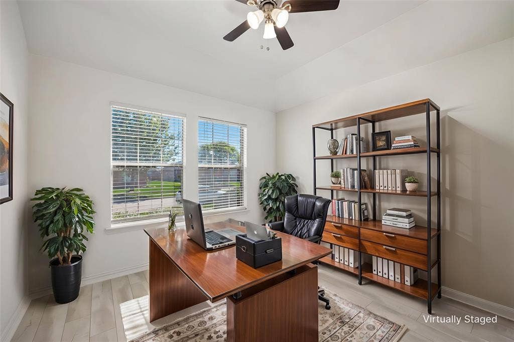 221 Cliffbrook Drive, Wylie, TX 75098 Light wood-finish flooring, two large windows with blinds, and a ceiling fan with integrated lighting