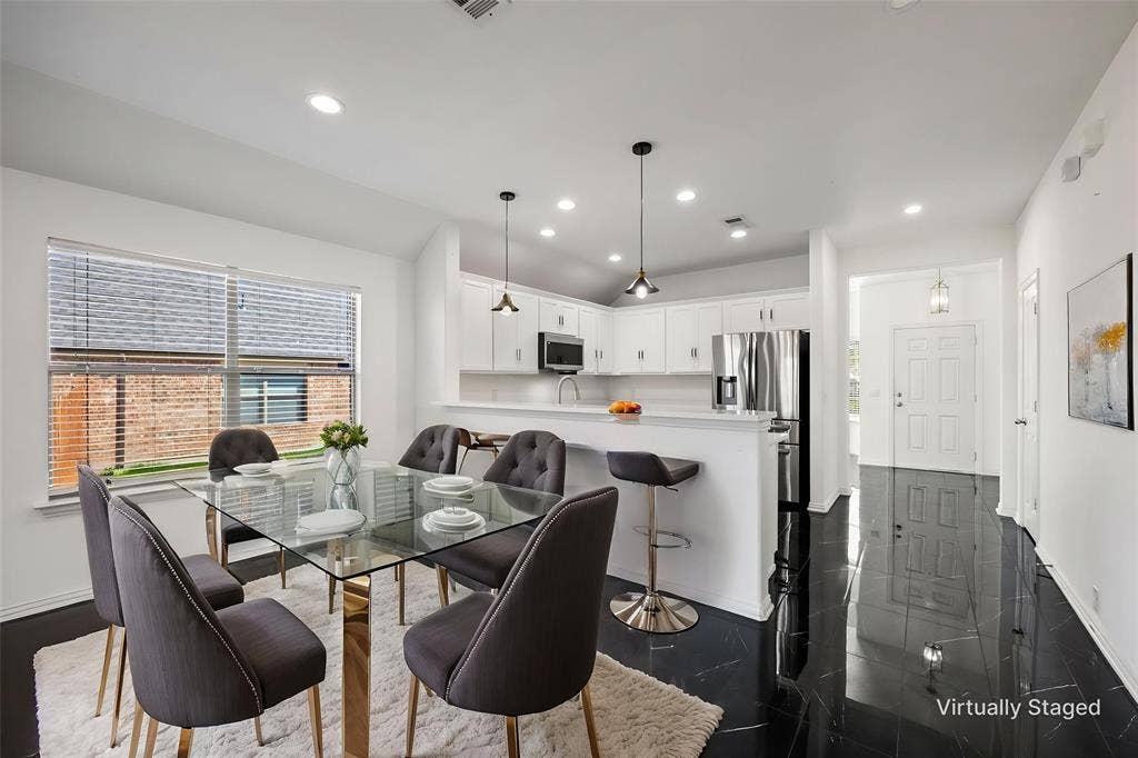 221 Cliffbrook Drive, Wylie, TX 75098 Contemporary kitchen with white cabinetry, stainless steel appliances, recessed lighting, and a breakfast bar